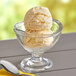 A bowl of Oringer Eggnog hard serve ice cream with a spoon.