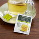 A glass of green tea with a Bigelow green tea bag on the table.