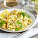 A plate of cauliflower with lemon and parsley on a table.