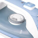 A white Hamilton Beach electric iron with a handle.