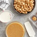 A bowl of Callebaut Gold Caramelized White Chocolate Callets on a counter in a professional kitchen.