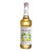 A bottle of Monin pear flavoring syrup with a white label.