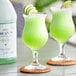 Two glasses of Narvon Margarita frozen cocktail with lime slices on the rim.