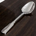 A Oneida Cityscape stainless steel teaspoon with a silver handle and bowl.