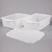 A group of three white plastic containers with lids.