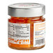 A case of 6 jars of Toschi Orange Peels in Syrup on a table in an organic food store.