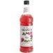 A Monin bottle of rose syrup with red liquid.