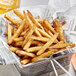 A basket of French fries with a close up of a Regal Ultimate French Fry Seasoning label.