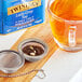 A close-up of a glass cup of Twinings Lady Grey tea.