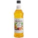 A Monin bottle of orange liquid.
