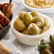 A bowl of Belosa Feta Cheese Stuffed green olives on a table.