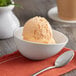 A bowl of Oringer Neutral Sherbet Base ice cream on a table with a spoon.