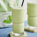 A glass of green David Rio Japanese Matcha Frappe.