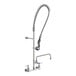 A T&S wall mounted pre-rinse faucet with a hose and hand held sprayer.