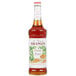 A bottle of Monin Peanut Butter Flavoring Syrup on a white background.