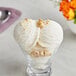 A clear glass bowl of Lloyd's of Pennsylvania hazelnut hard serve ice cream with nuts on top.