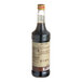 A close-up of a Monin Organic Chocolate Flavoring Syrup bottle filled with brown liquid with a label.