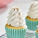 A cupcake with frosting on top.