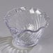 A clear polycarbonate tulip berry dish with a wavy edge.