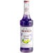 A bottle of Monin lavender lemon syrup with purple liquid.