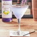 A glass of lavender lemon drink on a napkin.