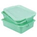 A stack of three green Vollrath Traex plastic containers with recessed lids.
