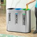 A stainless steel indoor trash can with three separate labeled compartments for waste, recycling, and compost.