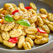 A plate of Seviroli potato gnocchi with peppers and herbs.