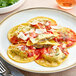 A plate of Seviroli Porcini and Truffle Round Ravioli with sauce and parmesan.