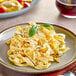 A plate of Seviroli Vertullo Tagliatelle pasta with basil leaves on it.