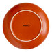 A round, orange porcelain coupe plate with the brand name 'Acopa' on the bottom.