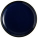 An Acopa Keystone Azora Blue porcelain coupe plate with a black rim.