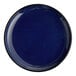 A large, round, deep blue porcelain coupe plate.