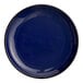 A close-up of a blue Acopa Keystone porcelain plate with a black rim.