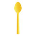 A yellow Design Specialties polycarbonate teaspoon with a handle.