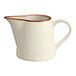 A white porcelain creamer with a brown rim.
