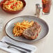 A plate of Acopa Keystone granite gray porcelain with steak and french fries.