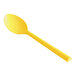 A close-up of a yellow Design Specialties polycarbonate soup spoon.