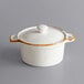 An Acopa Keystone white porcelain mini casserole with a white lid