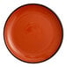 An orange Acopa Keystone porcelain coupe plate with a black rim.