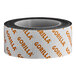 A roll of Gorilla Max Strength black mounting tape with orange and white text.