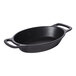 A black oval cast aluminum server with handles.