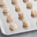 A tray of Pennant Parker House style wheat dinner roll dough on a white surface.