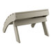 A grey Lancaster Table & Seating Adirondack footrest.