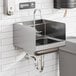 A Regency wall-mounted hand sink with a T&S faucet and side splash.