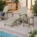 A gray Lancaster Table & Seating Adirondack side table on an outdoor patio.