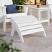 A white Adirondack footrest with slats next to a white Adirondack table.