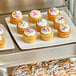 A tray of Abe's Vegan Vanilla Mini Cupcakes with frosting and sprinkles.
