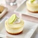 A Pearl River Pastry New York-style Key Lime mini cheesecake with a lime wedge on top.