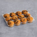 A tray of Abe's Vegan Chocolate Chip Mini Muffins on a gray surface.